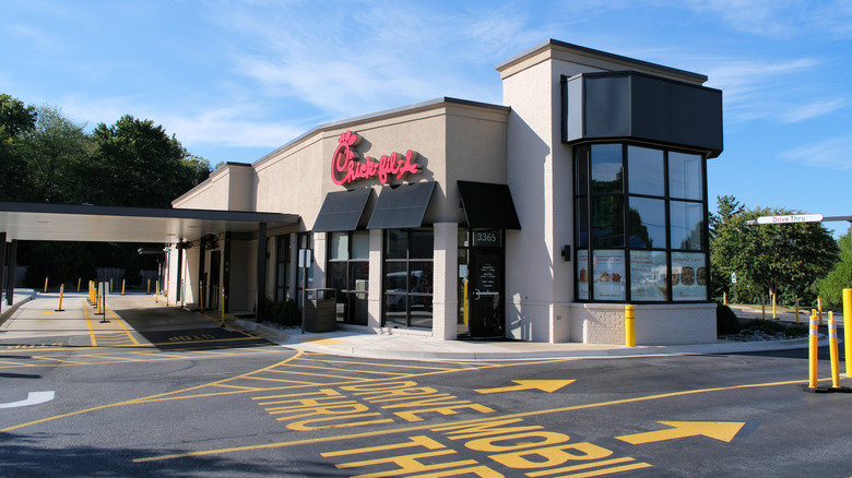Chick-fil-A restaurant in front of empty parking lot and blue sky