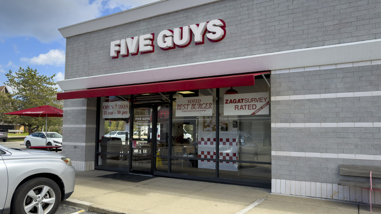 Five Guys restaurant with car parked outside