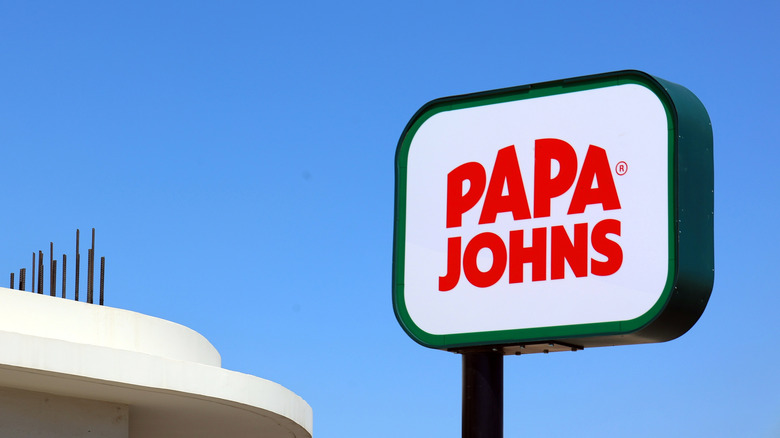Papa John's sign against blue sky