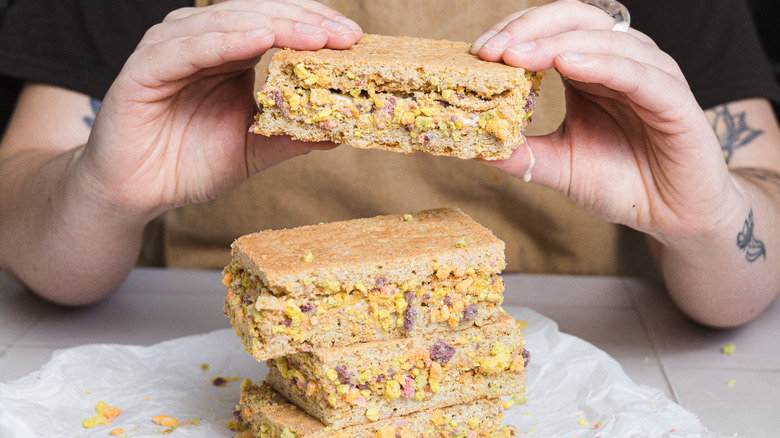 Person holding one ice cream sandwich over others