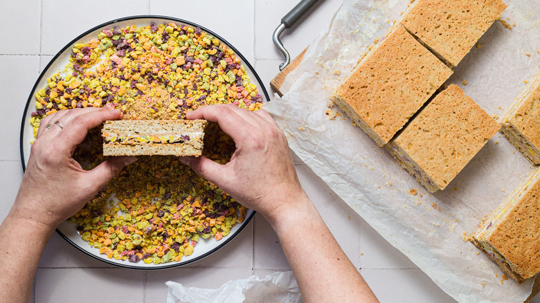 Rolling ice cream sandwich in cereal