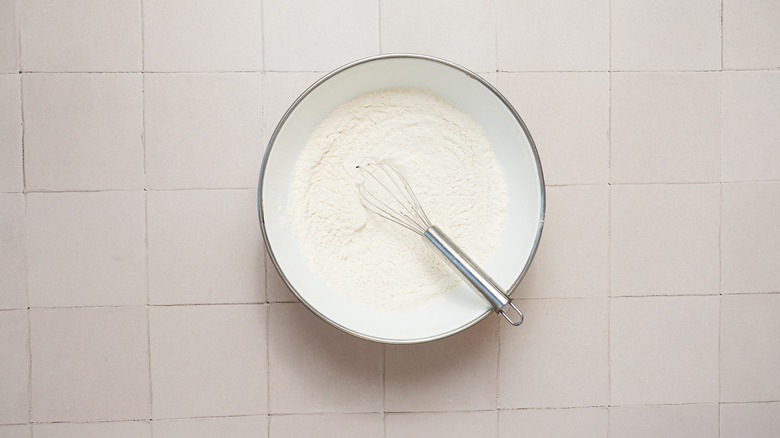 Dry ingredients in bowl with whisk