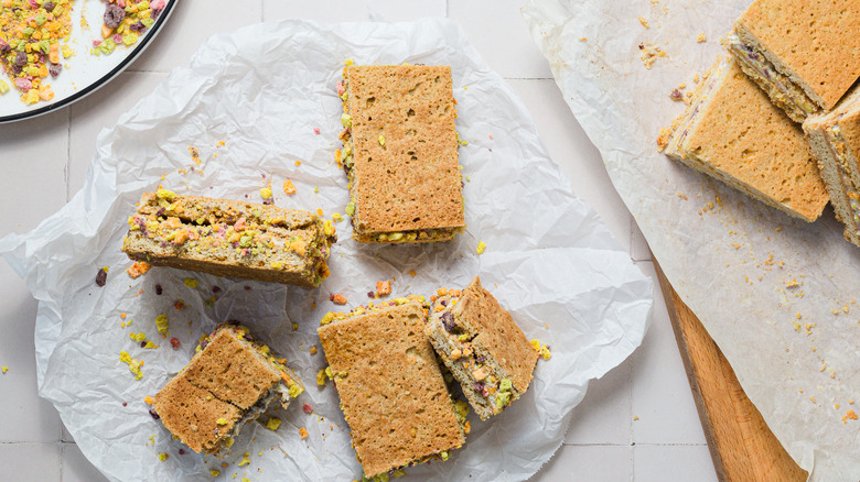 Four ice cream sandwiches on parchment paper with more on the side