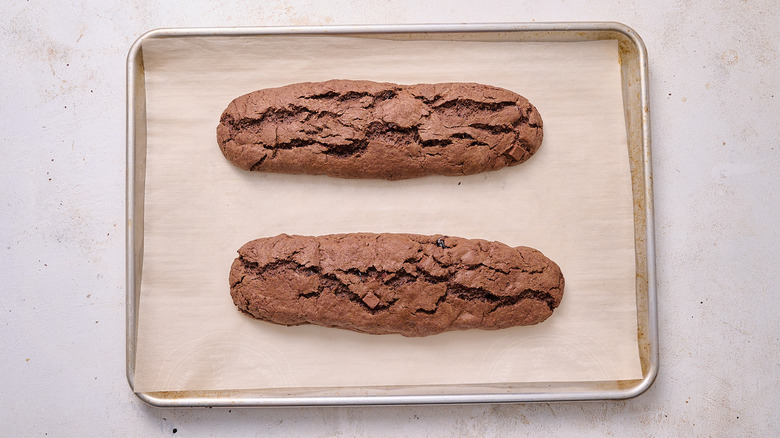 baked biscotti logs on baking sheet