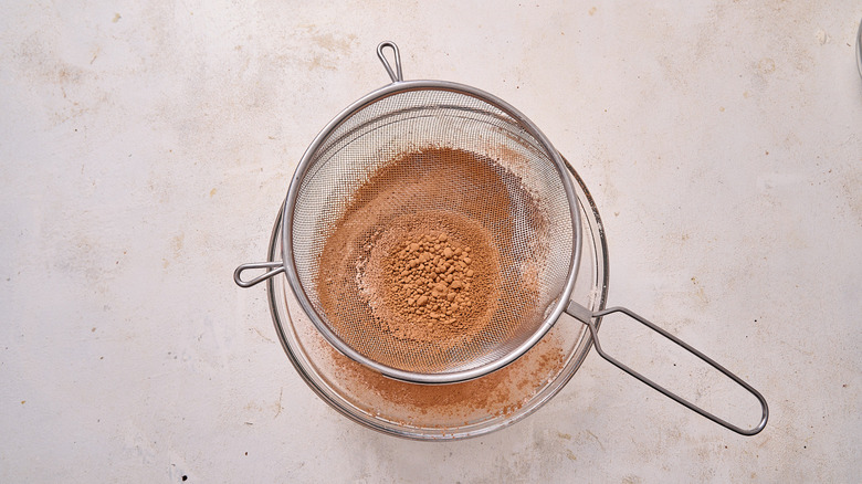 sifting dry ingredients into a bowl