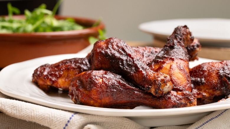 Close up of pile of Dr Pepper barbecue chicken on white plate