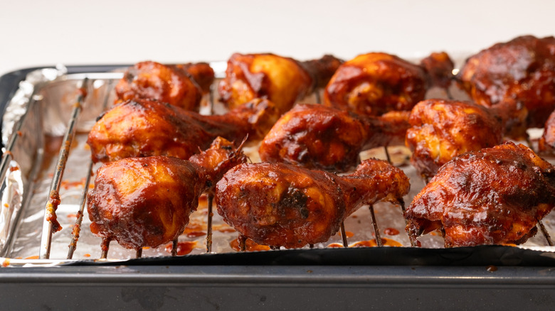 Dr Pepper barbecue chicken on wire rack on top of foil-lined baking sheet