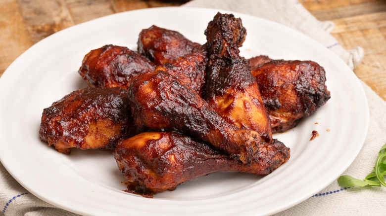A pile of Dr Pepper barbecue chicken on white plate