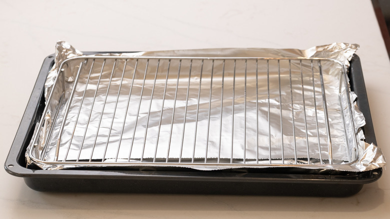 a wire rack on top of a baking sheet lined with foil