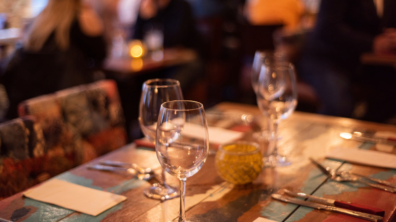 inside of a steakhouse with wine glasses on table