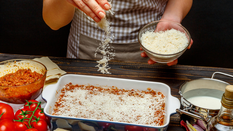 person making lasagna