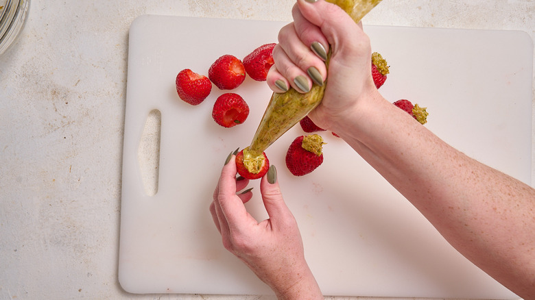 filling strawberries with pistachio cream
