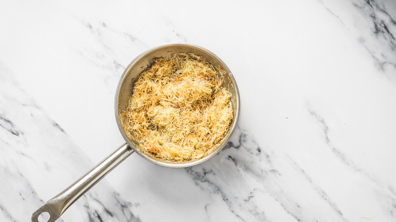 Pan with brown butter kataifi noodles.