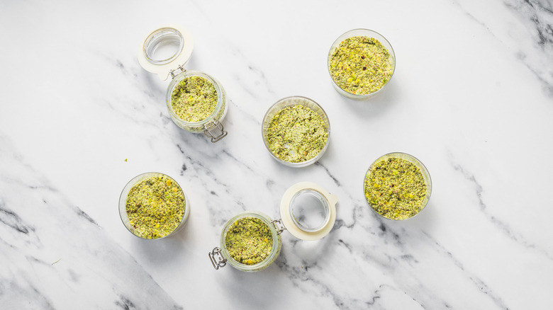 Glasses and jars with Dubai pistachio chia pudding.