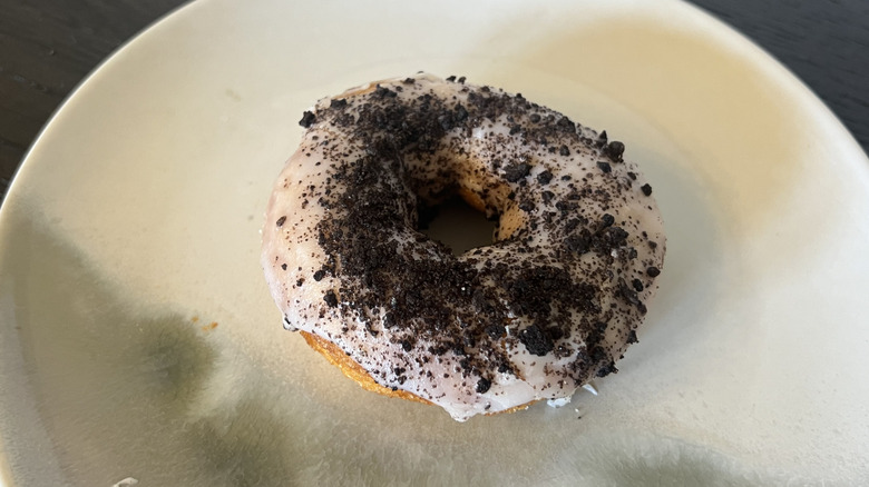 Duck Donuts Cookie Crumble donut on plate.