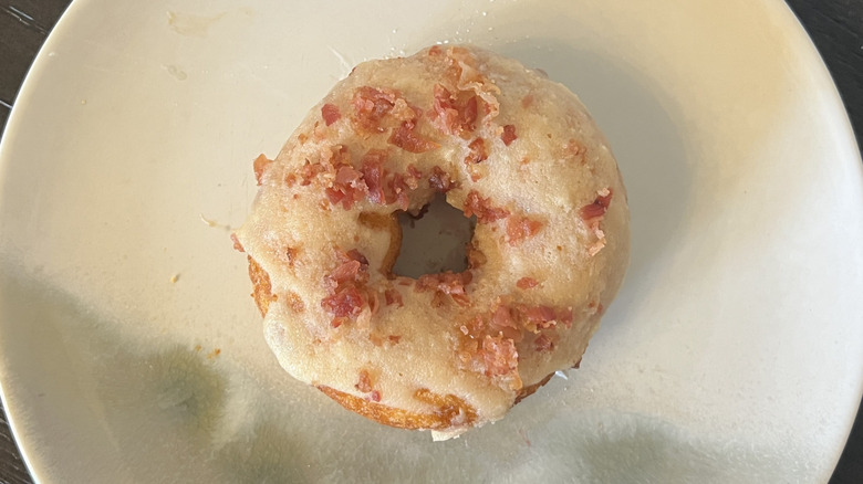 Duck Donuts Maple Bacon donut on plate.