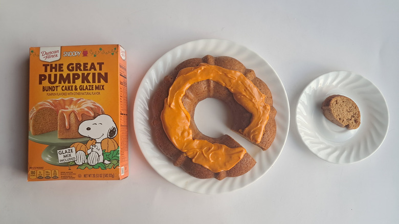 box of cake mix and bundt cake with orange frosting