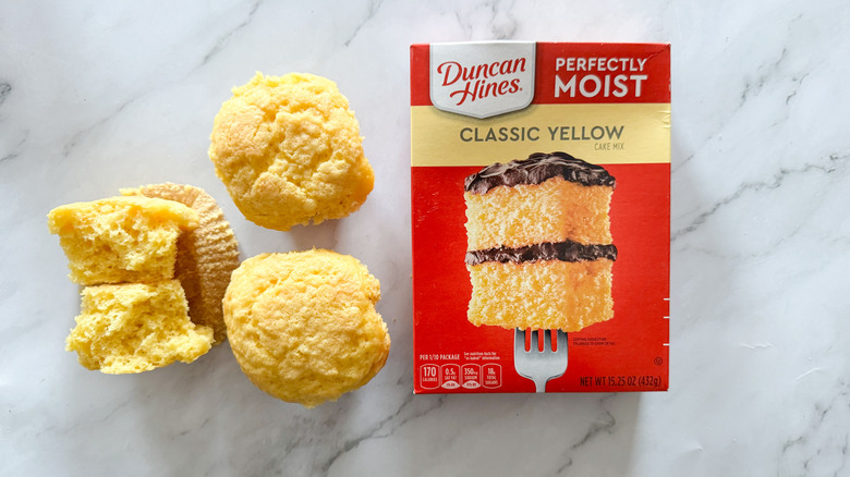 Overhead shot of Duncan Hines Classic Yellow cake mix and cupcakes prepared using the mix.