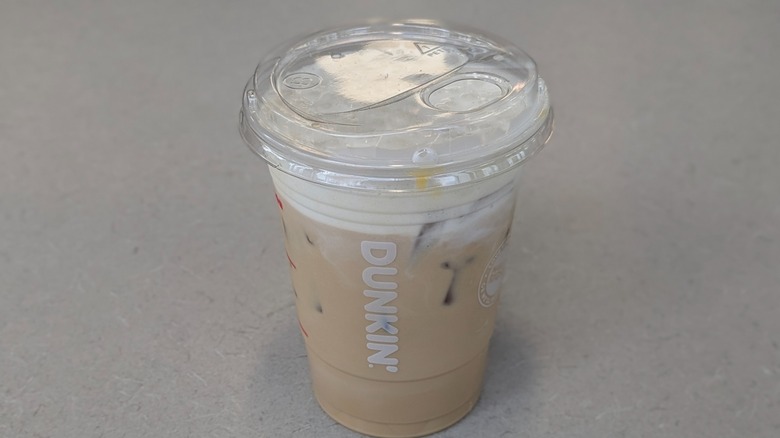 A Fluffernutter Cloud Latte from Dunkin' on a grey table