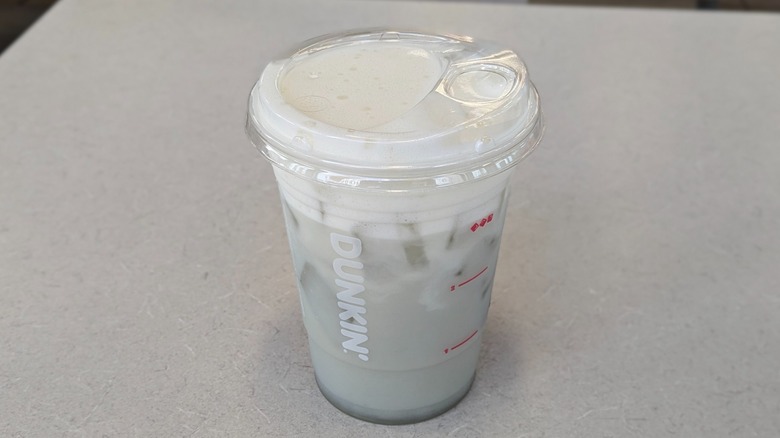 A Freeze Pop Suncloud Lemonade from Dunkin' on a grey table