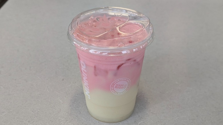 A Strawberry Suncloud Lemonade from Dunkin' on a grey table