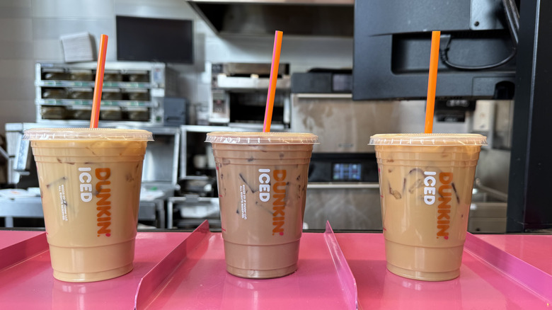 Dunkin iced drinks in different flavors and colors ready for pick up.