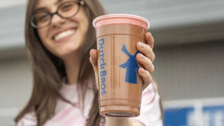 Customer holding Dutch Bros coffee drink