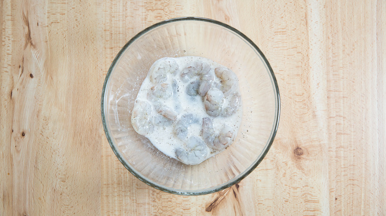 battered shrimp in mixing bowl