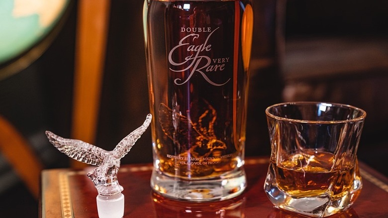 A bottle of Double Eagle Very Rare on a bar with a row of Eagle Rare 10-year bottles in the background