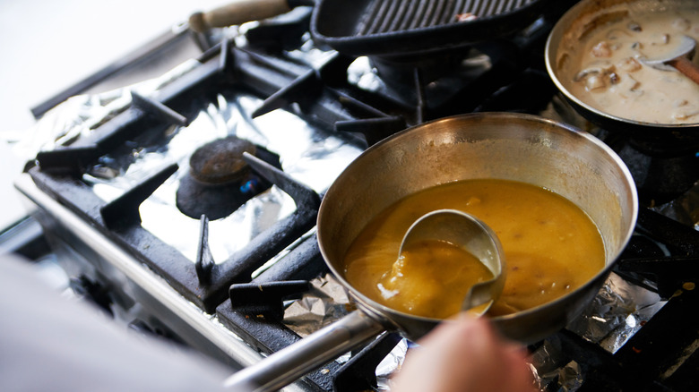 stirring gravy on stove