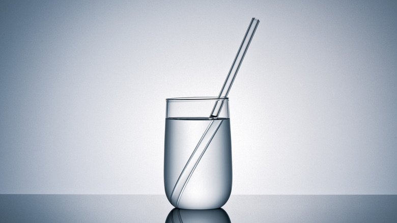 A beverage with a glass straw.