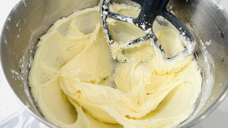 white frosting in a stand mixer bowl