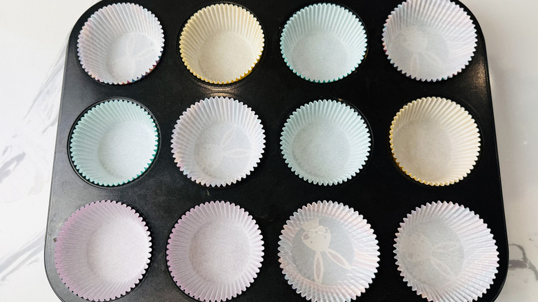 muffin pan filled with paper cupcake liners