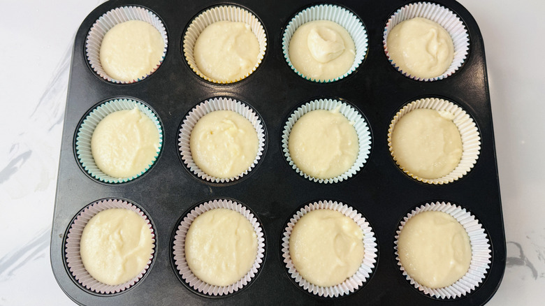 white cake batter in a muffin pan