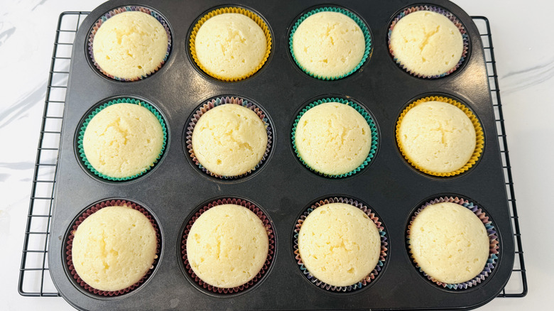 white cupcakes in a muffin pan