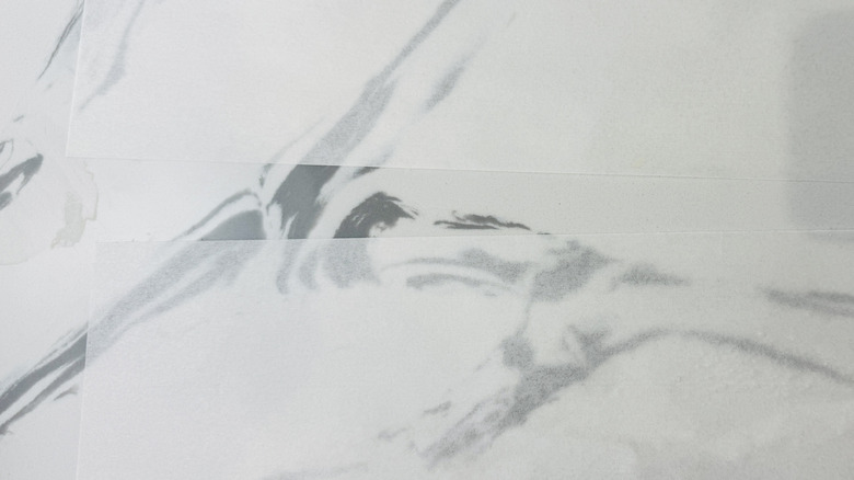 piece of white paper on a faux marble countertop