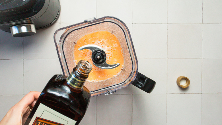 Adding liqueur to cantaloupe sorbet mix in blender