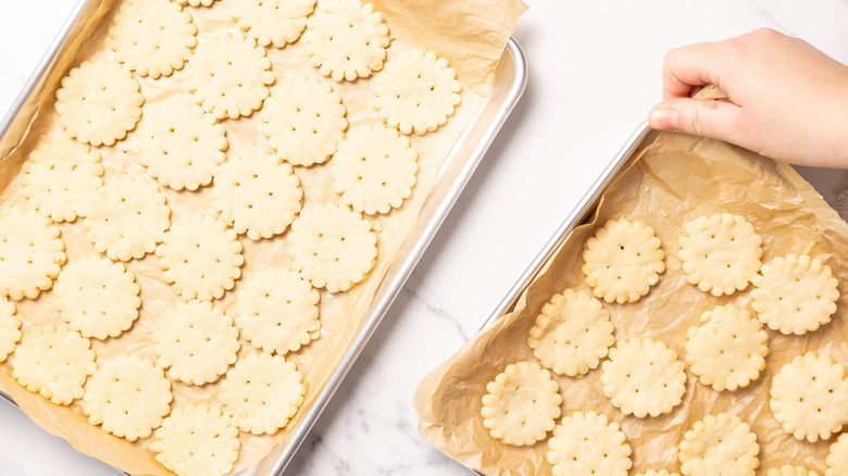 Arranging shortbread cookies on baking sheets.