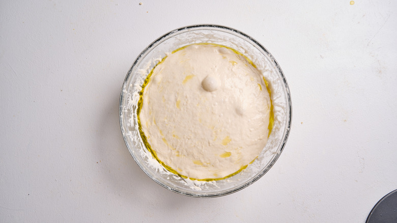 dough proofing in a covered bowl