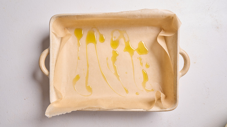 baking dish prepared with parchment and oil