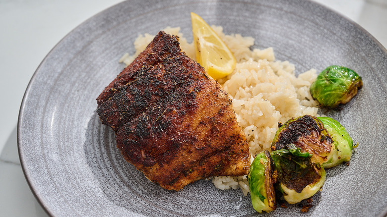 Blackened grouper filet on a plate with rice