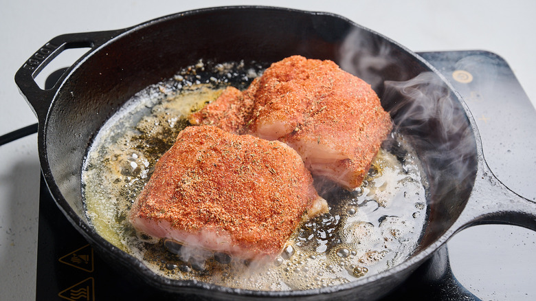 searing fish in a skillet with butter