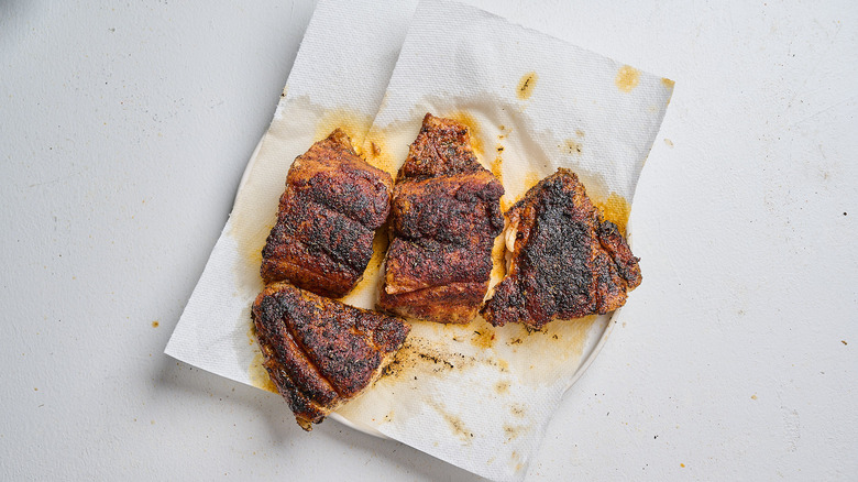 cooked fish on a paper towel lined plate
