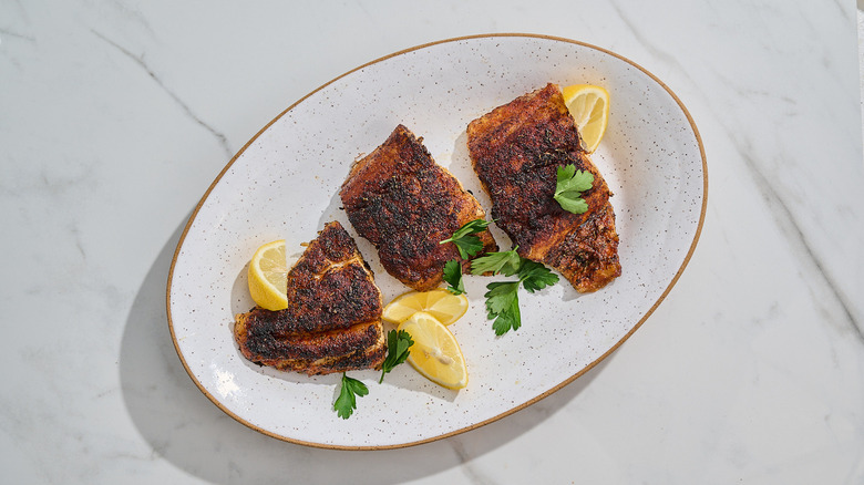 blackened grouper filets on a platter