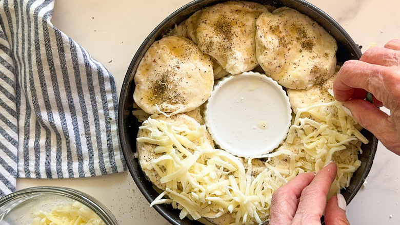 hand adding cheese
