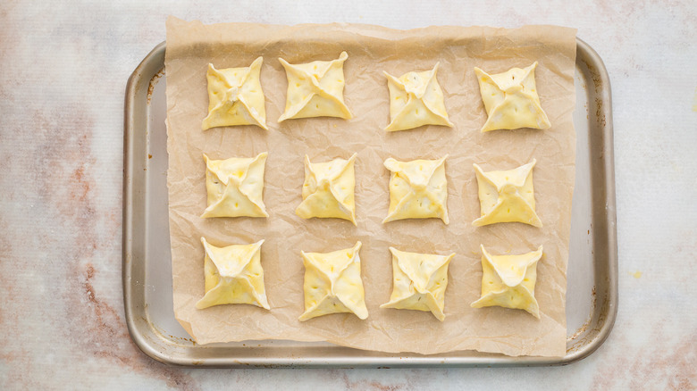 stuff pastries on baking sheet