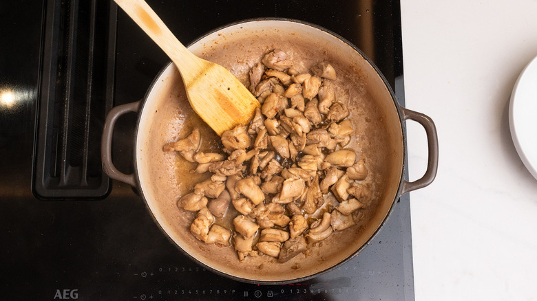 chicken frying in a pan