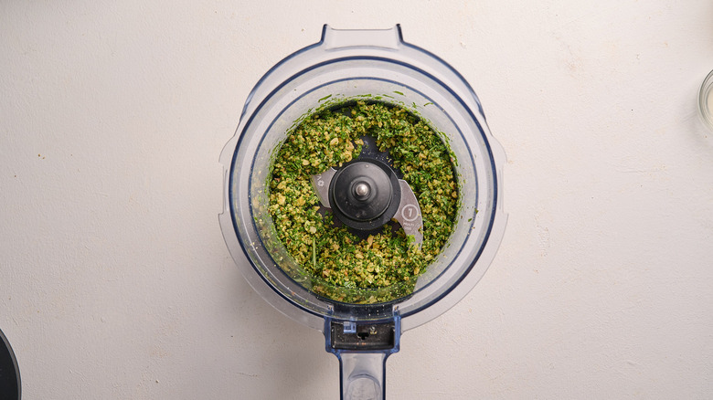 basil and nuts chopped in a food processor