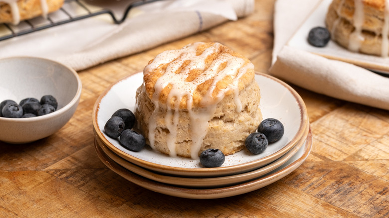 glazed cinnamon biscuit on plate with blueberries