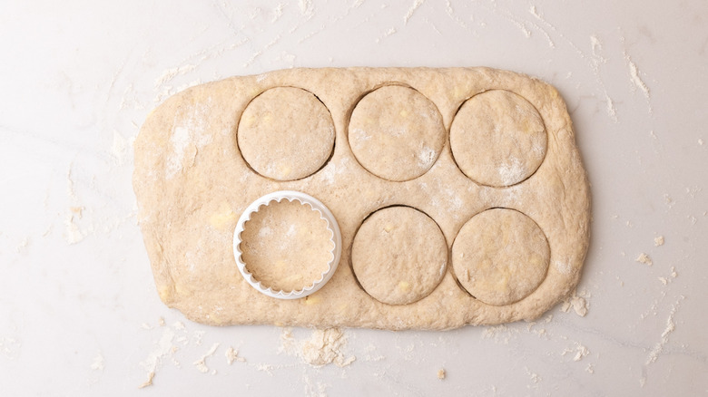 cutting cinnamon biscuits from dough